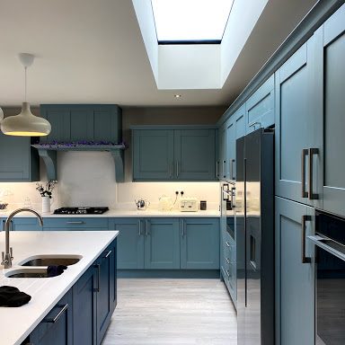 Stylish new kitchen with green and navy doors